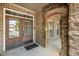Welcoming front door area with brick and stone accents, showcasing the home's charming architectural details at 4116 Argyle Trl, Burlington, NC 27215