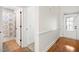 Hallway with hardwood floors, connecting the main areas and leading to a bathroom, showcasing a practical layout at 4116 Argyle Trl, Burlington, NC 27215