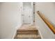 Carpeted hallway featuring white walls, a wooden banister, and access to various rooms at 4116 Argyle Trl, Burlington, NC 27215