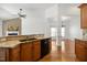 Bright open kitchen with granite counters, wood cabinets, hardwood flooring, and stainless steel appliances at 4116 Argyle Trl, Burlington, NC 27215