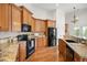 Kitchen featuring granite countertops, stainless steel appliances, hardwood floors, and ample wood cabinetry at 4116 Argyle Trl, Burlington, NC 27215