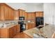 Bright kitchen features wood cabinets, granite counters, and stainless steel appliances at 4116 Argyle Trl, Burlington, NC 27215