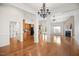 Spacious living room with hardwood floors seamlessly connects to the kitchen at 4116 Argyle Trl, Burlington, NC 27215