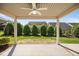Covered patio features a ceiling fan and views of the manicured backyard at 4116 Argyle Trl, Burlington, NC 27215