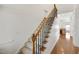 Elegant staircase with hardwood steps and wrought iron railings, leading to the upper level of the home at 4116 Argyle Trl, Burlington, NC 27215