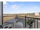 Outdoor balcony with chairs, side table and view of the surrounding neighborhood at 412 Gaston Park Ln # 200, Wake Forest, NC 27587