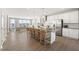 Open kitchen boasts a large island with bar seating, stainless appliances, and hardwood floors at 412 Gaston Park Ln # 200, Wake Forest, NC 27587