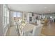 Elegant dining room with large windows, modern table, and seamless flow to kitchen at 414 Gaston Park Ln # 200, Wake Forest, NC 27587