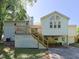 The house has a backyard featuring a deck, lattice, and staircase that leads to the upper level of the home at 4205 Woodlawn Dr, Raleigh, NC 27616
