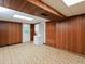 Finished basement with wood paneling, tile floors and a laundry area at 4205 Woodlawn Dr, Raleigh, NC 27616