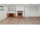 Spacious finished basement with a brick fireplace and built in shelving at 4205 Woodlawn Dr, Raleigh, NC 27616