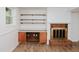 Basement featuring a fireplace and built in shelving along white walls at 4205 Woodlawn Dr, Raleigh, NC 27616
