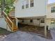 View of elevated home construction showing access to the basement space and exterior stairs at 4205 Woodlawn Dr, Raleigh, NC 27616