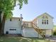 View of the raised foundation and covered basement area with wood stairs and door to the backyard at 4205 Woodlawn Dr, Raleigh, NC 27616