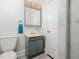 A charming bathroom features a gray vanity, tile flooring, and a marble shower at 4205 Woodlawn Dr, Raleigh, NC 27616