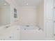 Bright bathroom featuring a soaking tub, tiled floors and ample storage at 4205 Woodlawn Dr, Raleigh, NC 27616