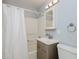 Bathroom featuring a shower with a curtain, a vanity, and a toilet at 4205 Woodlawn Dr, Raleigh, NC 27616