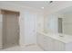 Bright bathroom featuring a glass shower, double vanity and tiled floors at 4205 Woodlawn Dr, Raleigh, NC 27616