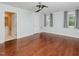 Bright bedroom featuring hardwood floors, a ceiling fan, and neutral paint at 4205 Woodlawn Dr, Raleigh, NC 27616