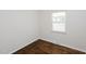 A room showcases hardwood floors and natural light from a window at 4205 Woodlawn Dr, Raleigh, NC 27616