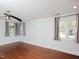 Spacious bedroom featuring hardwood floors, neutral paint, and natural light from multiple windows at 4205 Woodlawn Dr, Raleigh, NC 27616