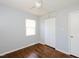 Bedroom with hardwood floors, ceiling fan and a closet with white doors at 4205 Woodlawn Dr, Raleigh, NC 27616
