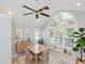 Cozy dining room featuring large windows, neutral walls, stylish decor and a ceiling fan at 4205 Woodlawn Dr, Raleigh, NC 27616