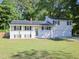 Charming two-story home with an attached garage, solar panels, and a well-maintained lawn at 4205 Woodlawn Dr, Raleigh, NC 27616