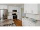 The renovated kitchen has stainless steel appliances, white cabinets, and a unique countertop at 4205 Woodlawn Dr, Raleigh, NC 27616