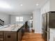 Open concept kitchen with a large kitchen island, modern appliances, and hardwood flooring at 4205 Woodlawn Dr, Raleigh, NC 27616