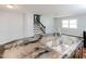 Kitchen island with sink and a unique granite countertop; hardwood flooring and view to stairwell at 4205 Woodlawn Dr, Raleigh, NC 27616