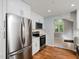 Modern kitchen features stainless steel appliances, white cabinets, and recessed lighting at 4205 Woodlawn Dr, Raleigh, NC 27616
