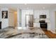 Bright kitchen features white cabinets, stainless steel appliances, and an island with seating and sink at 4205 Woodlawn Dr, Raleigh, NC 27616