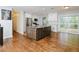 Spacious eat-in kitchen with granite countertops, stainless steel appliances, and hardwood floors at 4205 Woodlawn Dr, Raleigh, NC 27616