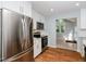 Bright kitchen with stainless appliances, white cabinets, and access to the backyard at 4205 Woodlawn Dr, Raleigh, NC 27616