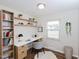This office features natural light, wooden floors, built-in shelving, and a modern desk at 4205 Woodlawn Dr, Raleigh, NC 27616