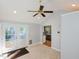 Room with tan tile flooring, neutral walls, and views to the kitchen and backyard patio at 4205 Woodlawn Dr, Raleigh, NC 27616