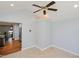 Neutral walls, tile flooring, and a ceiling fan within the interior of the home at 4205 Woodlawn Dr, Raleigh, NC 27616