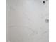 A bright shower features modern showerhead and white marble tiling throughout at 4205 Woodlawn Dr, Raleigh, NC 27616