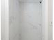 A shower showcases marble tiles from floor to ceiling and a modern showerhead at 4205 Woodlawn Dr, Raleigh, NC 27616