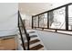 View of a modern staircase and decorative wrought iron railing with an open-concept floor plan at 4205 Woodlawn Dr, Raleigh, NC 27616