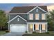 Charming two-story home with gray siding, white trim, a two-car garage, and a welcoming front porch at 428 Providence Springs Ln, Fuquay Varina, NC 27526