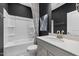 Modern bathroom featuring dark walls and a tub and shower combo at 429 Providence Springs Ln, Fuquay Varina, NC 27526