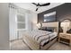 Well-lit bedroom featuring soft carpet, large window, modern ceiling fan, and neutral decor at 429 Providence Springs Ln, Fuquay Varina, NC 27526