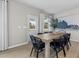 Dining room with a view to the backyard, wood floors, a large table, and a decorative tree at 429 Providence Springs Ln, Fuquay Varina, NC 27526