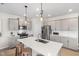 Open-concept kitchen with a large island, stainless steel appliances, and shaker-style cabinets at 429 Providence Springs Ln, Fuquay Varina, NC 27526