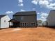New construction home with a spacious backyard awaiting landscaping, featuring a covered porch for outdoor relaxation at 4317 Emeline Way # 12, Fuquay Varina, NC 27526