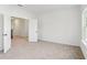 Spacious bedroom with neutral carpet, white walls, and natural light from the window at 4317 Emeline Way # 12, Fuquay Varina, NC 27526