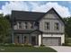 Charming two-story home with gray siding, stone accents, and a welcoming front porch at 4317 Emeline Way # 12, Fuquay Varina, NC 27526