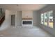 Bright and open living room featuring a modern fireplace and multiple windows at 4317 Emeline Way # 12, Fuquay Varina, NC 27526
